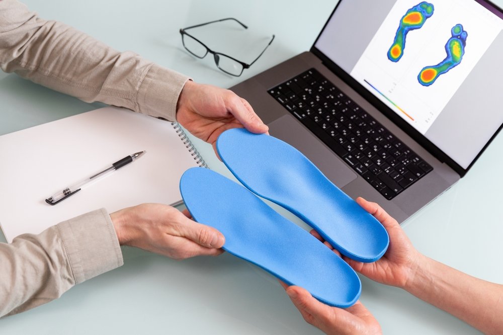 Doctor presenting custom orthotics